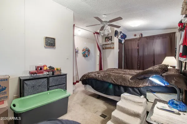 a bedroom with a bed dresser and a chair