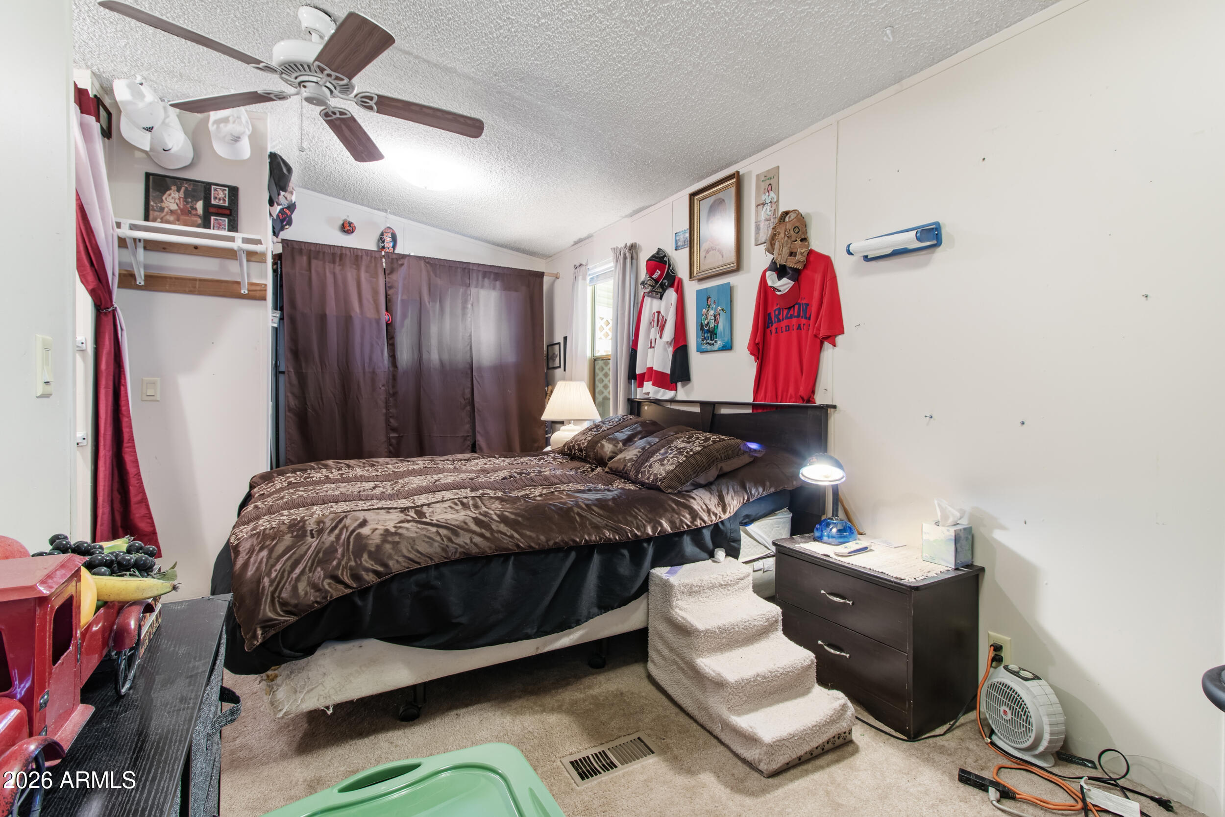 2121 North Center Street, Unit 15 Mesa, AZ 85201 - Photo 16 of 50 a bed room with a bed and a couch