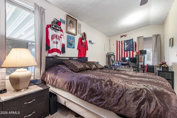 a bedroom with a bed and a window