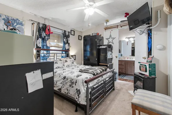 a bed room with a bed and a flat screen tv