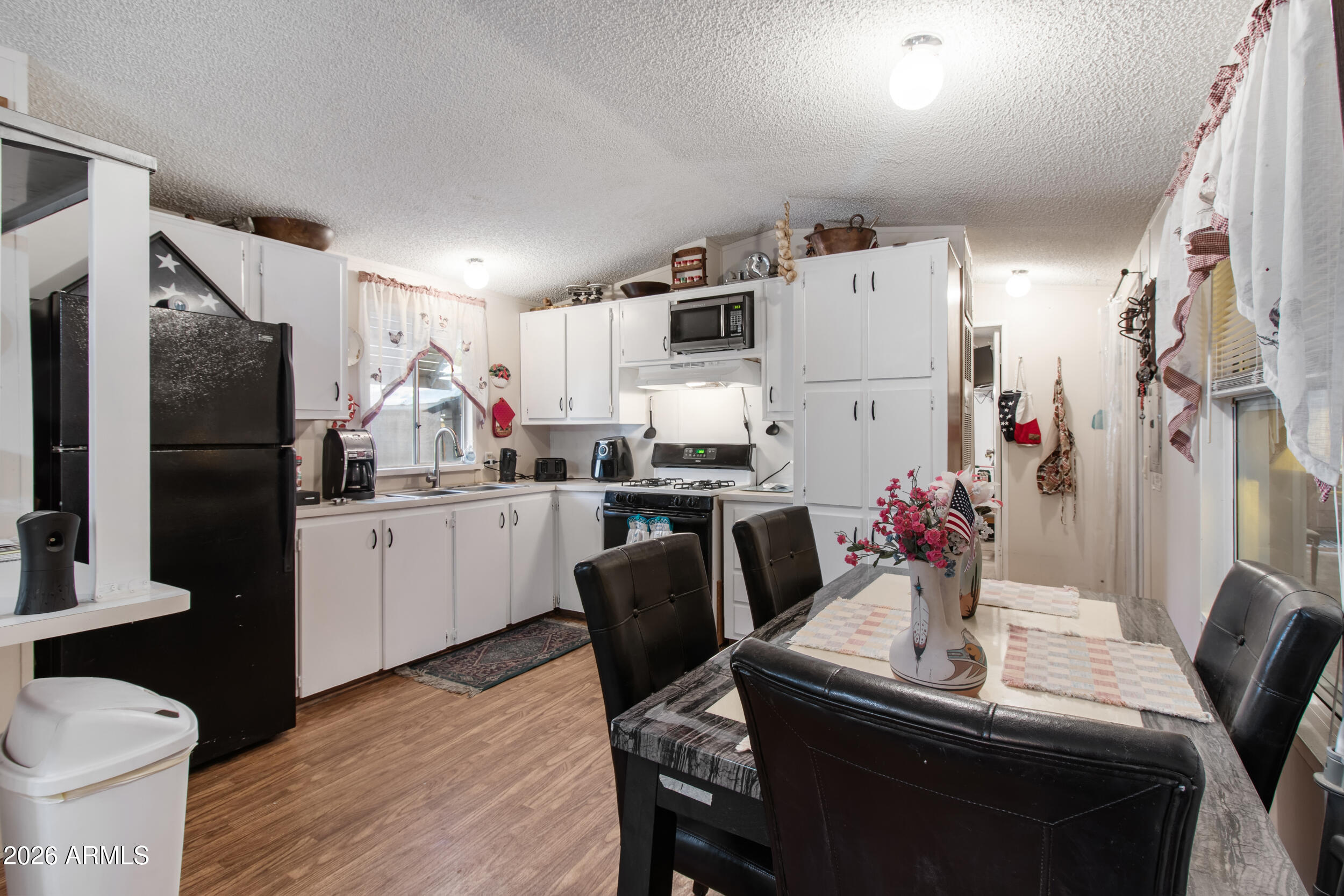 2121 North Center Street, Unit 15 Mesa, AZ 85201 - Photo 2 of 50 a dining room with furniture and wooden floor