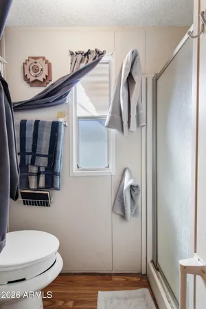 a bathroom with a toilet and a mirror