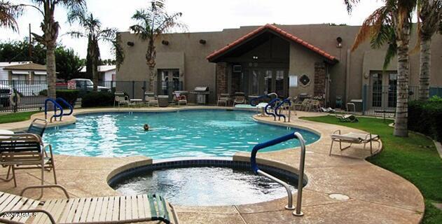 2121 North Center Street, Unit 15 Mesa, AZ 85201 - Photo 38 of 50 a view of swimming pool with outdoor seating and plants