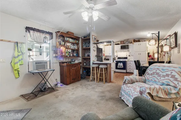 a living room with furniture a dining table and chairs