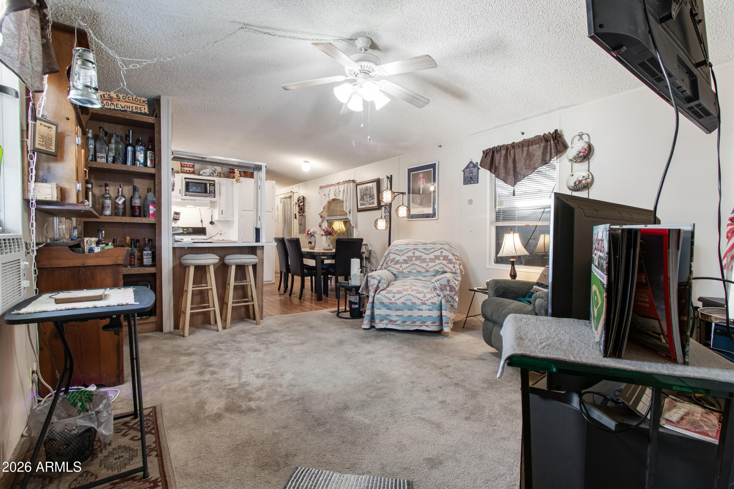 2121 North Center Street, Unit 15 Mesa, AZ 85201 - Photo 6 of 50 a living room with furniture and a flat screen tv