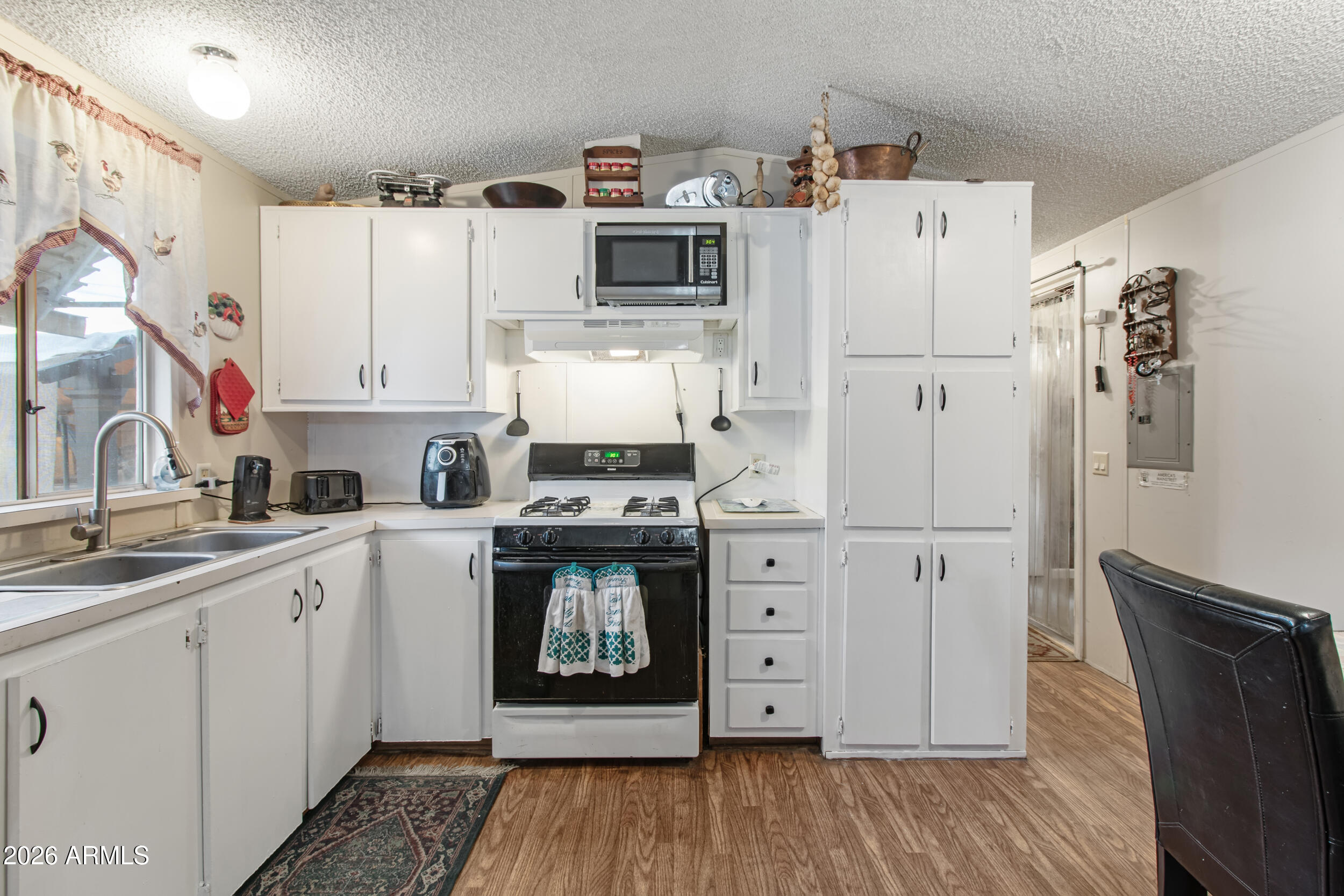2121 North Center Street, Unit 15 Mesa, AZ 85201 - Photo 8 of 50 a kitchen with stainless steel appliances a refrigerator stove and sink