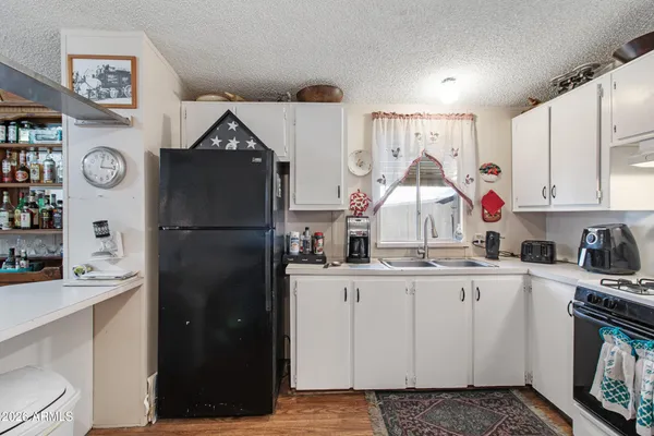 a kitchen with stainless steel appliances granite countertop a refrigerator and a stove