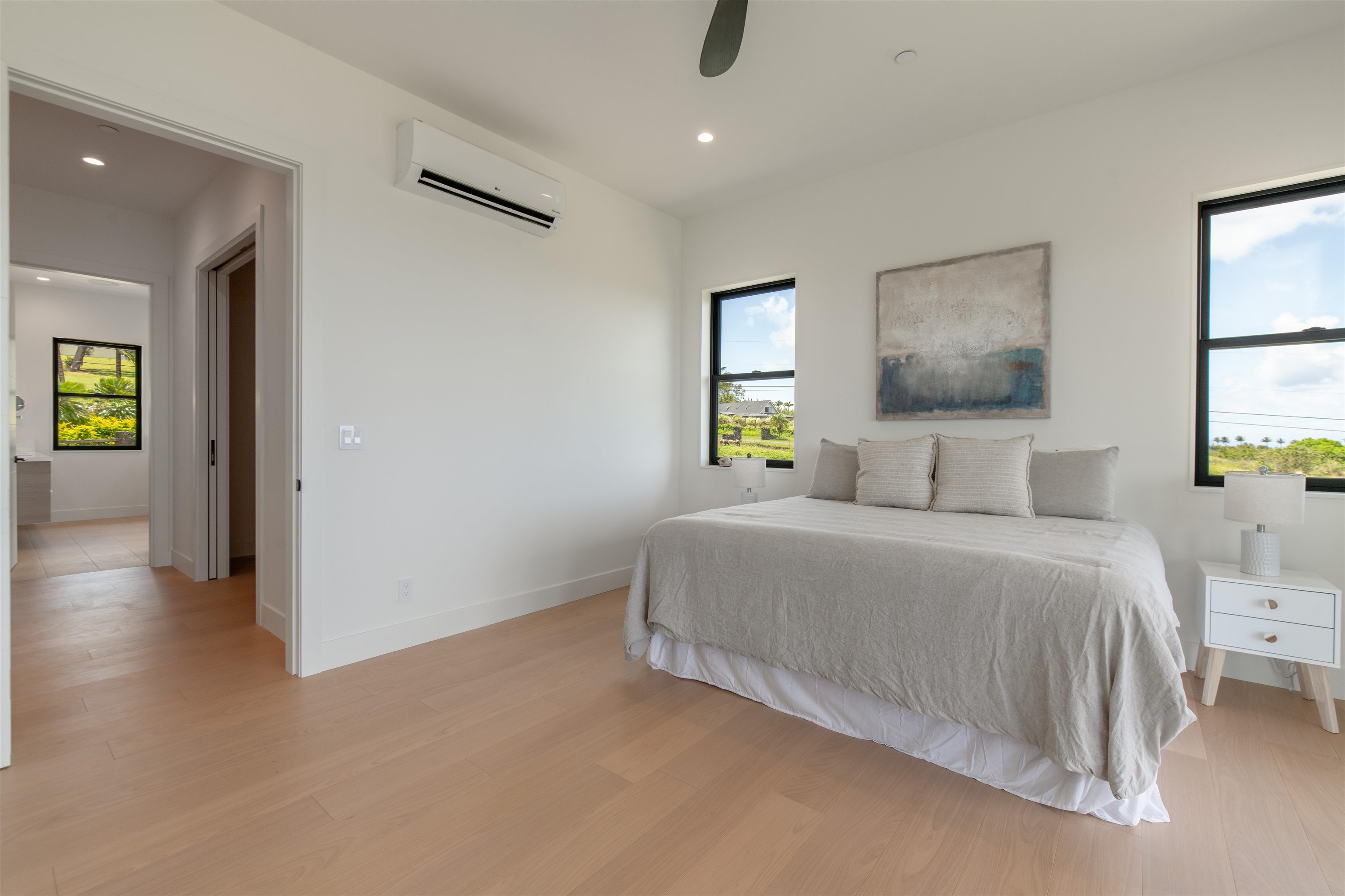 111 Mehana Road, Unit A Haiku, HI 96708 - Photo 45 of 50 a bedroom with a bed and painting on the wall