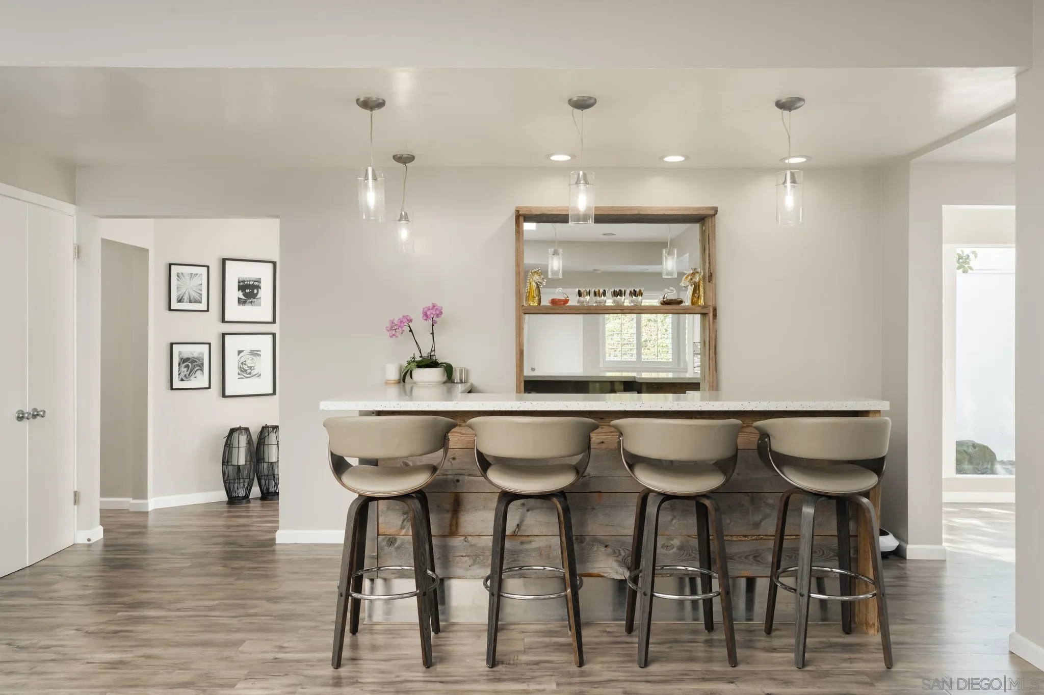 7026 Estrella De Mar Road Carlsbad, CA 92009 - Photo 14 of 46 a kitchen with a dining table chairs and wooden floor