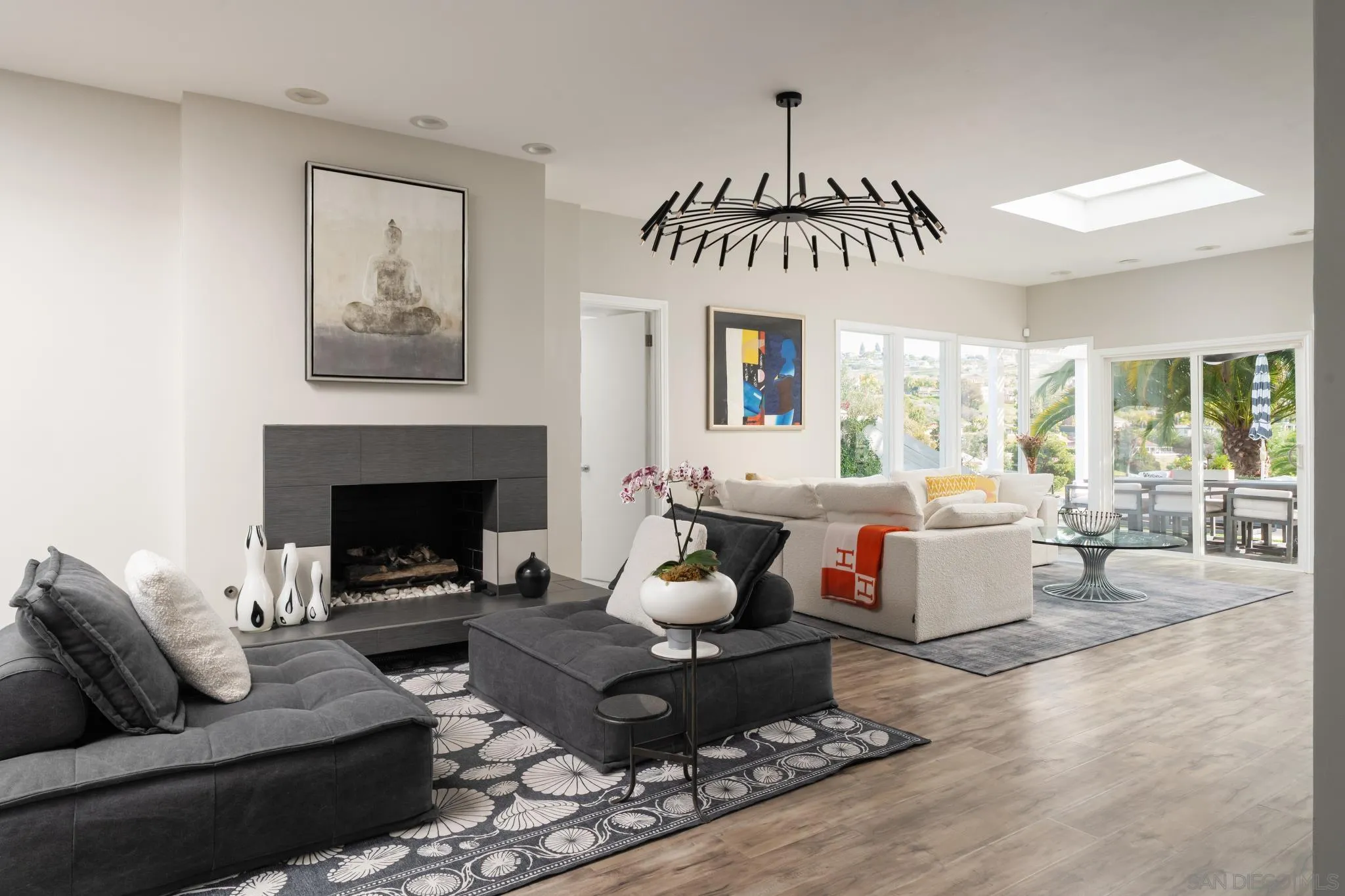 7026 Estrella De Mar Road Carlsbad, CA 92009 - Photo 15 of 46 a living room with furniture dining table a fireplace and a large window