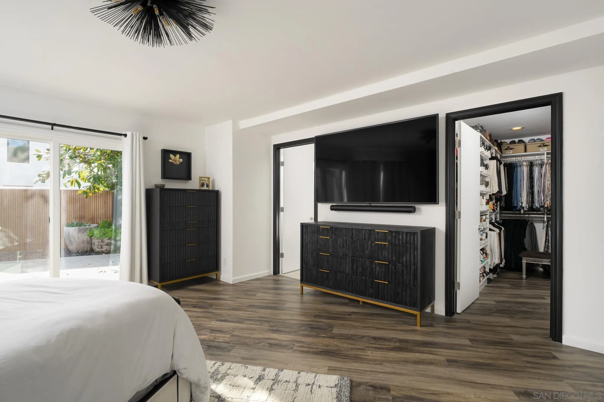 7026 Estrella De Mar Road Carlsbad, CA 92009 - Photo 22 of 46 a bedroom with a bed and a television