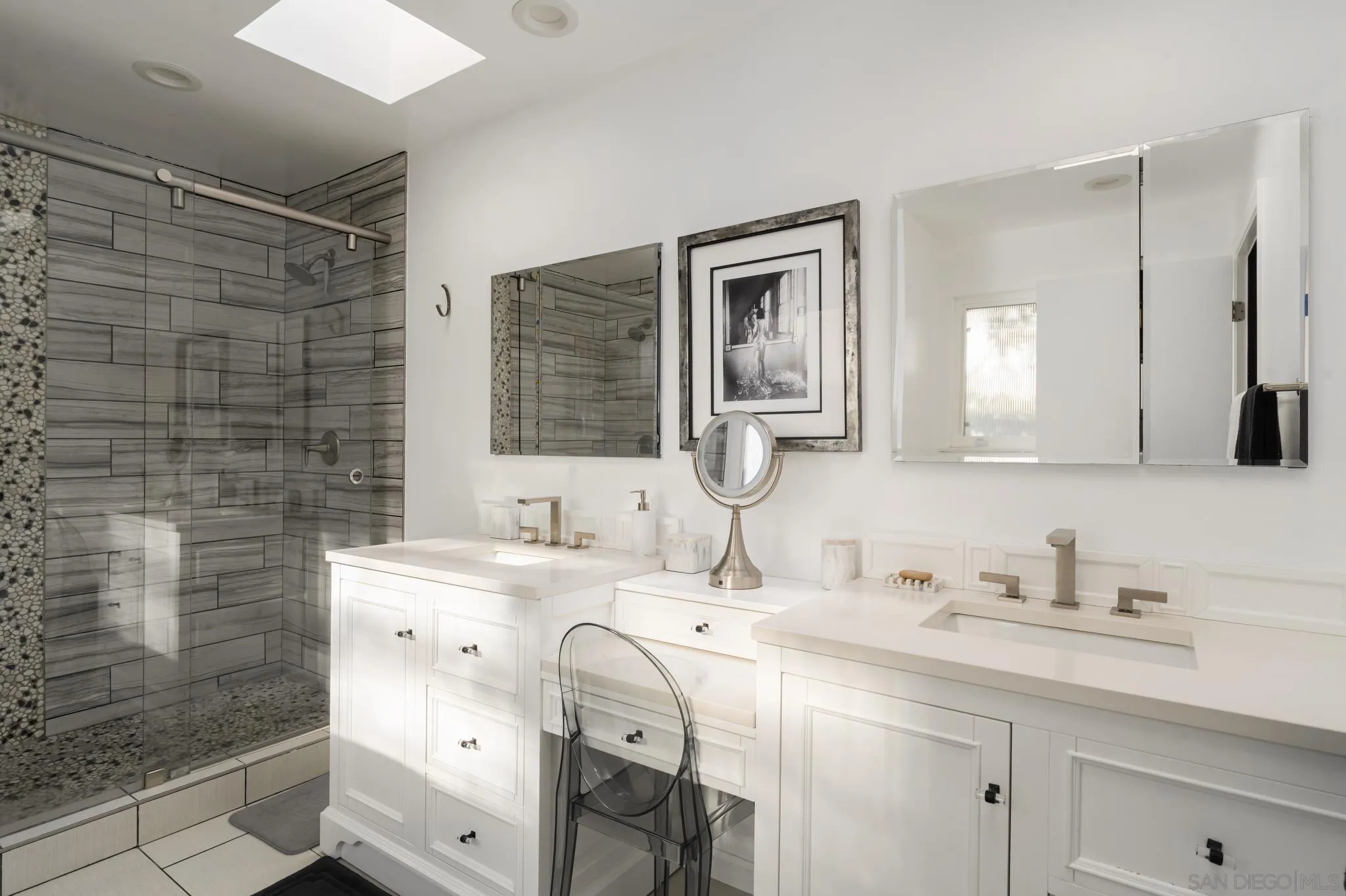 7026 Estrella De Mar Road Carlsbad, CA 92009 - Photo 24 of 46 a bathroom with a sink double vanity and a shower