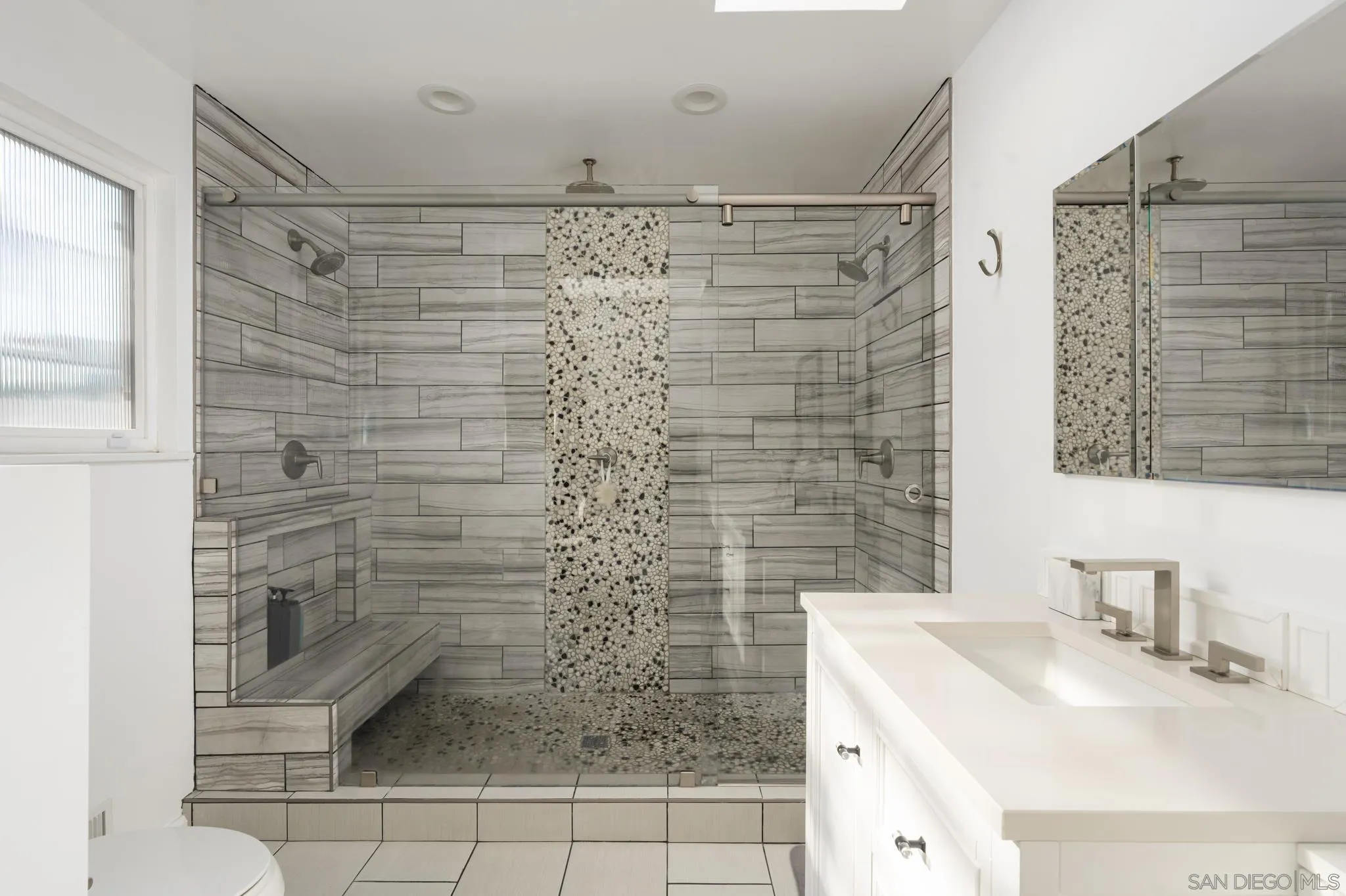 7026 Estrella De Mar Road Carlsbad, CA 92009 - Photo 25 of 46 a bathroom with a shower toilet and sink