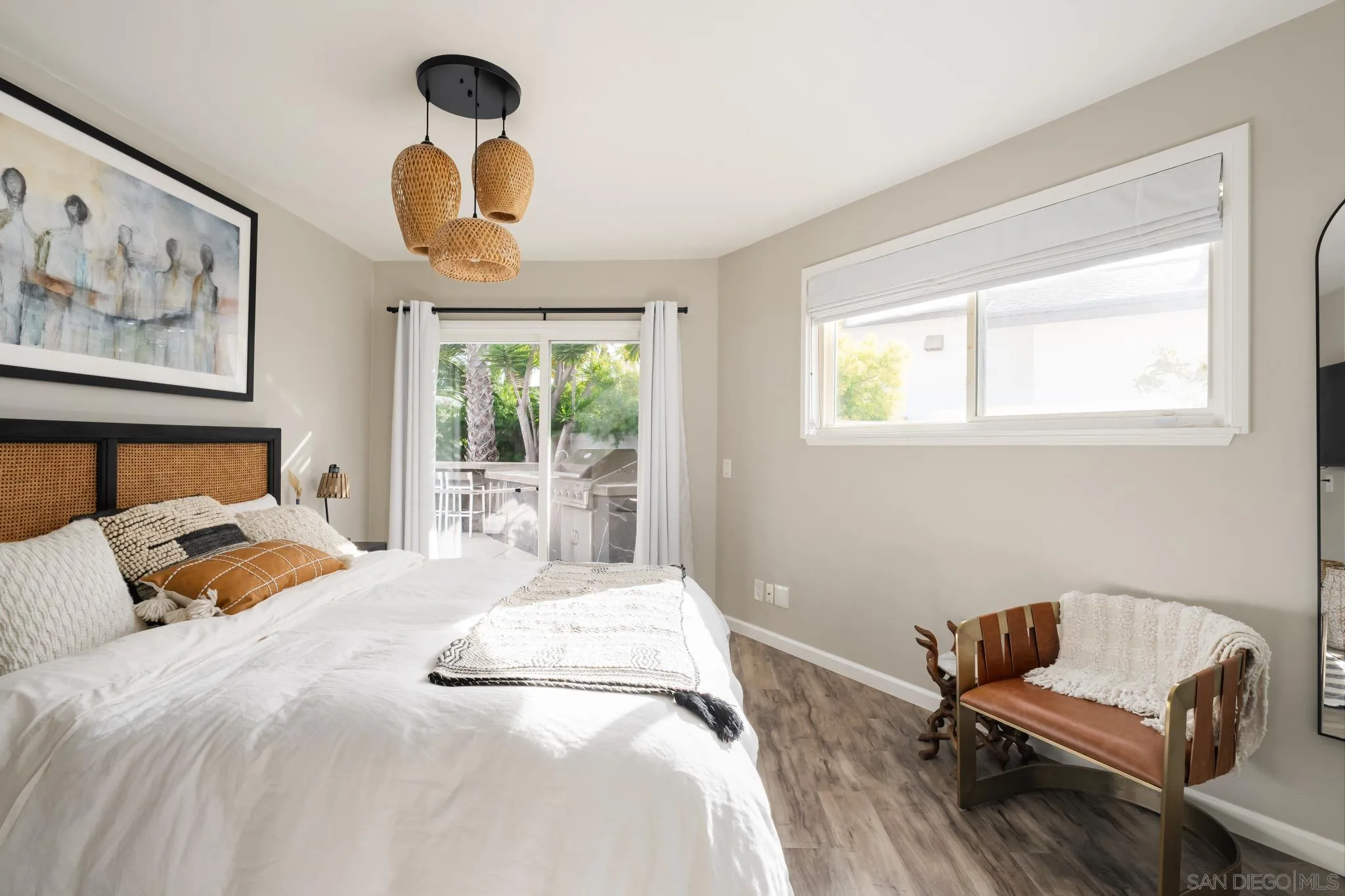 7026 Estrella De Mar Road Carlsbad, CA 92009 - Photo 34 of 46 a bedroom with a bed and wooden floor