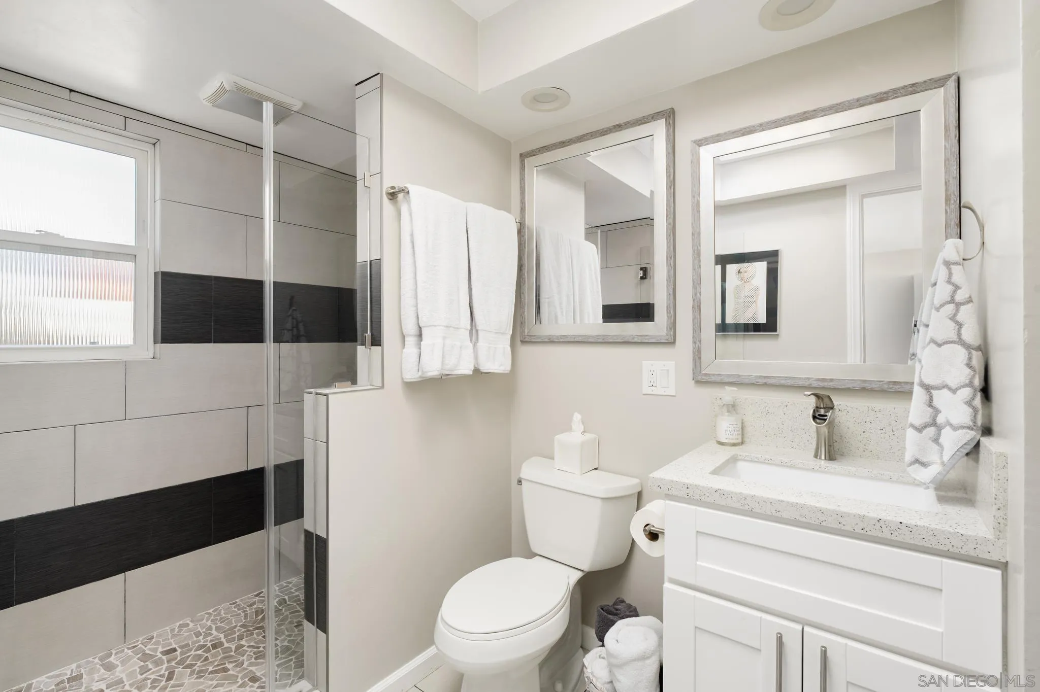 7026 Estrella De Mar Road Carlsbad, CA 92009 - Photo 36 of 46 a bathroom with a toilet a sink and a mirror