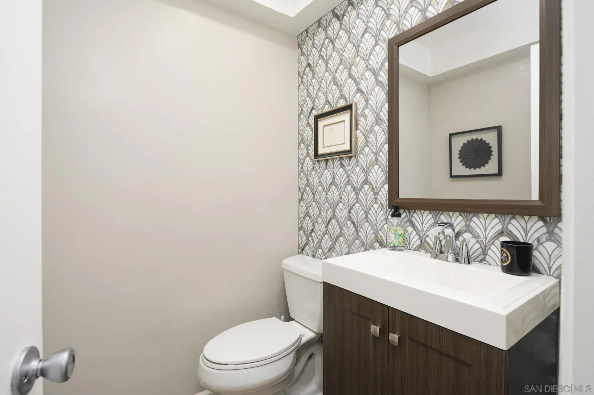 7026 Estrella De Mar Road Carlsbad, CA 92009 - Photo 42 of 46 a bathroom with a sink a toilet and mirror
