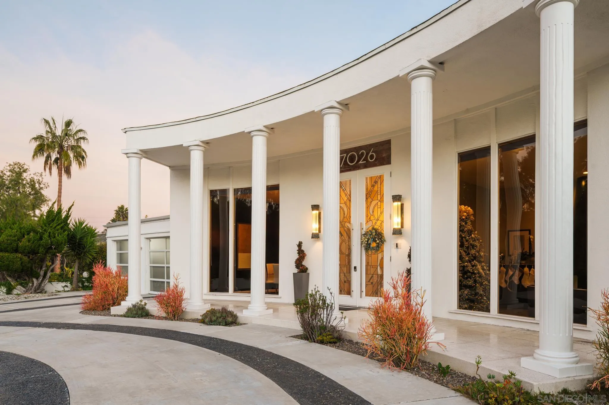 7026 Estrella De Mar Road Carlsbad, CA 92009 - Photo 46 of 46 a front view of a house with a yard and glass windows