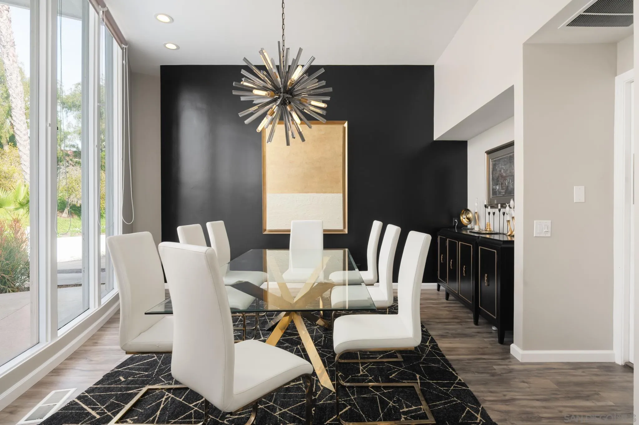 7026 Estrella De Mar Road Carlsbad, CA 92009 - Photo 5 of 46 a dining room with furniture a chandelier and wooden floor