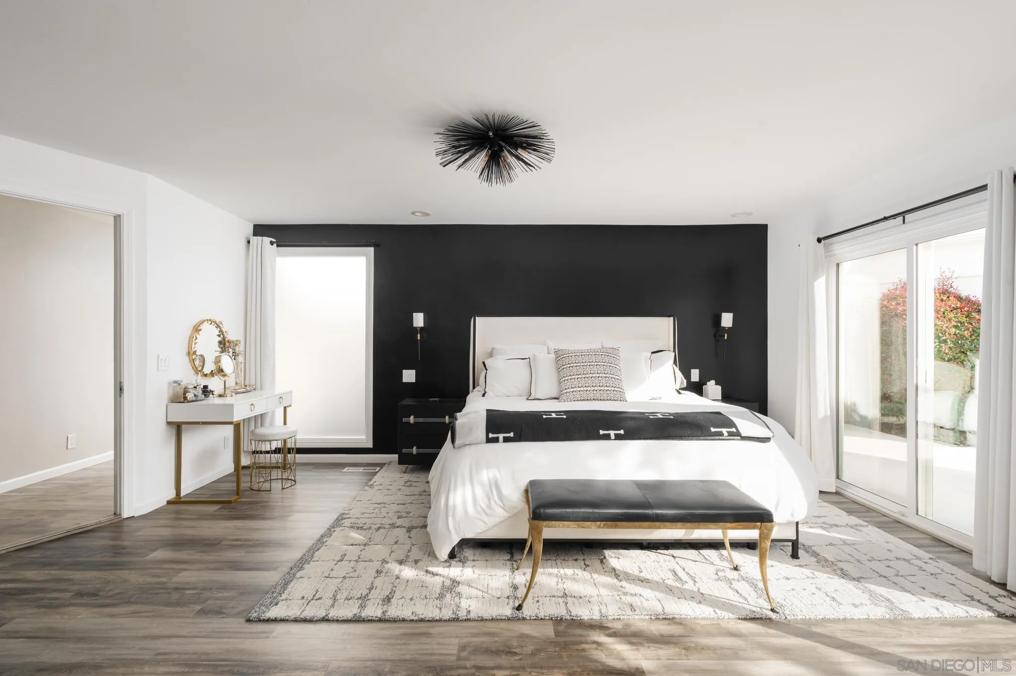 7026 Estrella De Mar Road Carlsbad, CA 92009 - Photo 8 of 46 a bedroom with a bed and wooden floor