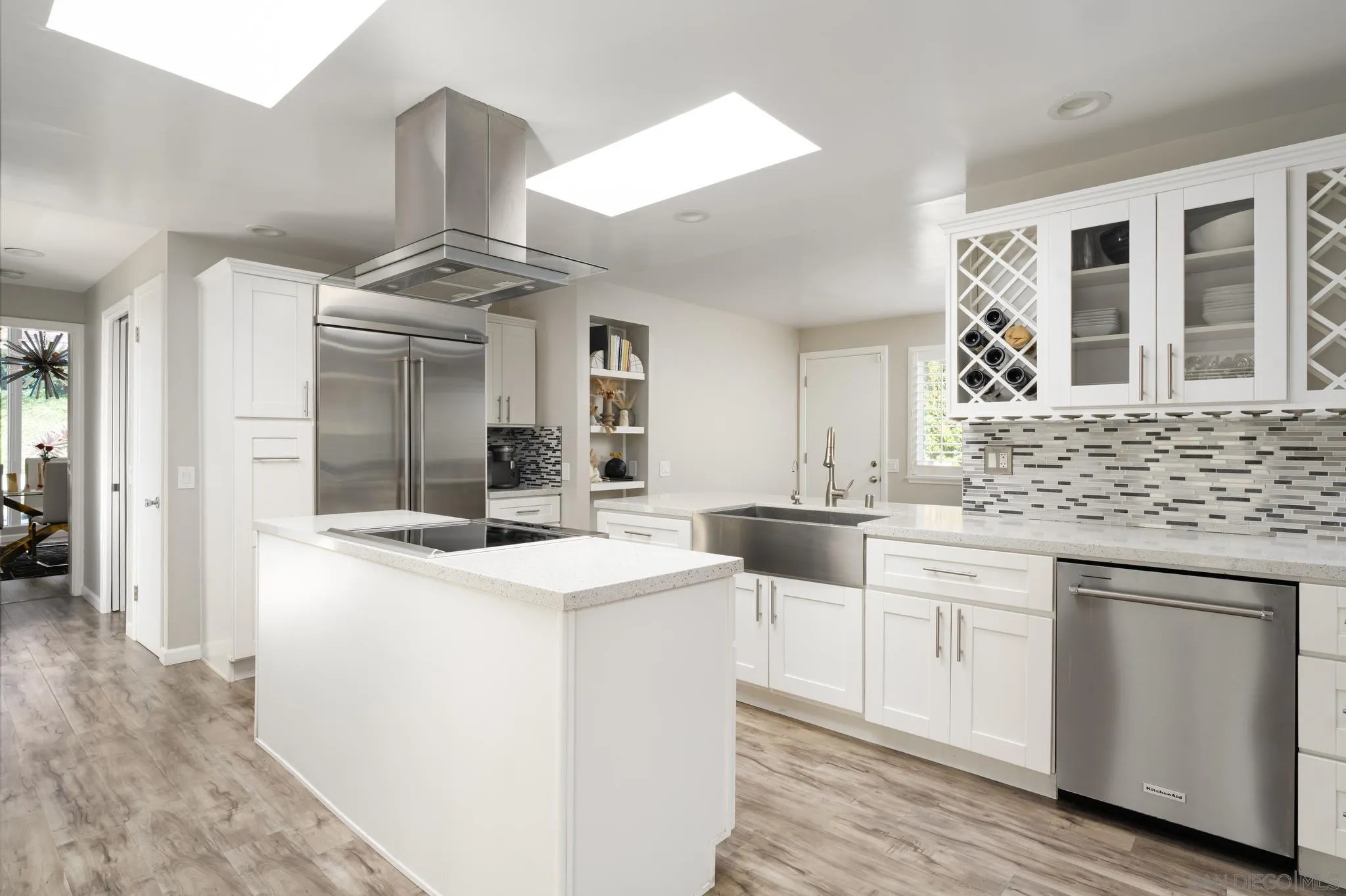 7026 Estrella De Mar Road Carlsbad, CA 92009 - Photo 10 of 46 a kitchen with stainless steel appliances kitchen island granite countertop a sink and cabinets