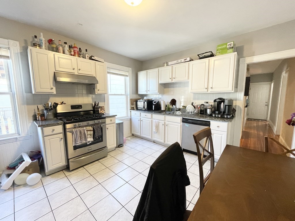 9 Taft Street, Unit 3 Boston, MA 02125 - Photo 2 of 10 a kitchen with a sink a stove and cabinets