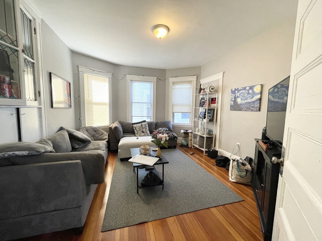 9 Taft Street, Unit 3 Boston, MA 02125 - Photo 3 of 10 a living room with furniture rug and a window