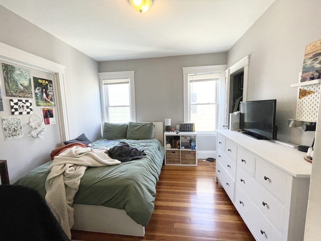 9 Taft Street, Unit 3 Boston, MA 02125 - Photo 4 of 10 a bedroom with furniture and a flat screen tv