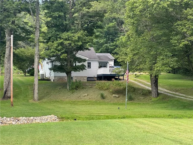 a backyard of a house with lots of green space