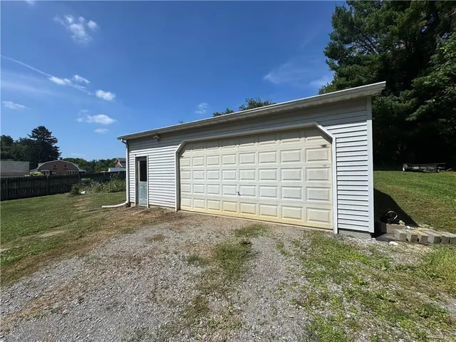 a view of a house with a backyard