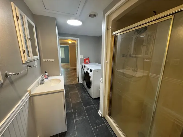 a bathroom with a sink a mirror and shower