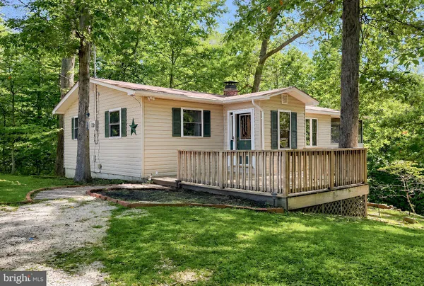 a view of a house with a yard and deck