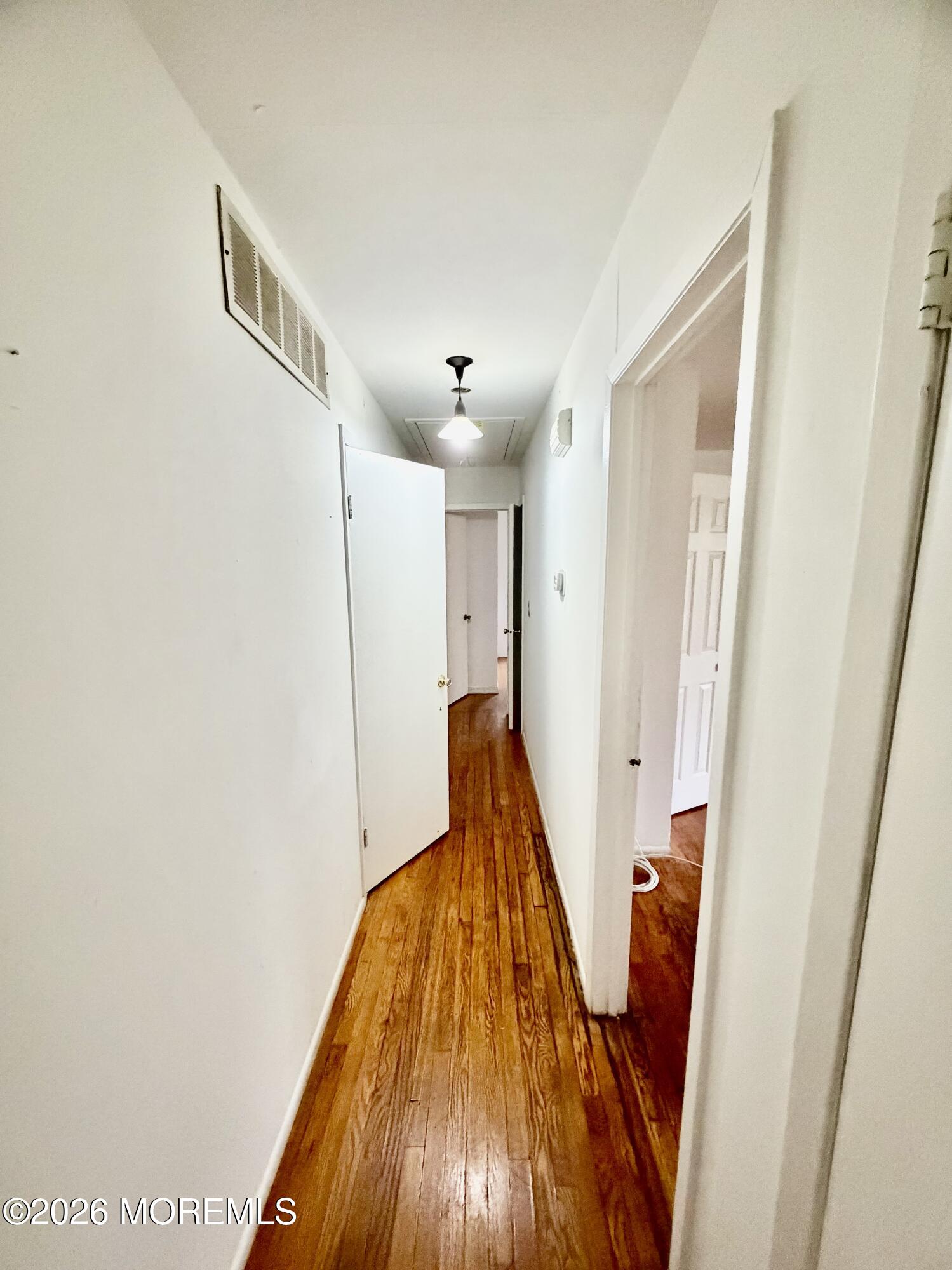 350 Bartley Road Jackson, NJ 08527 - Photo 15 of 29 a view of a hallway with wooden floor and staircase