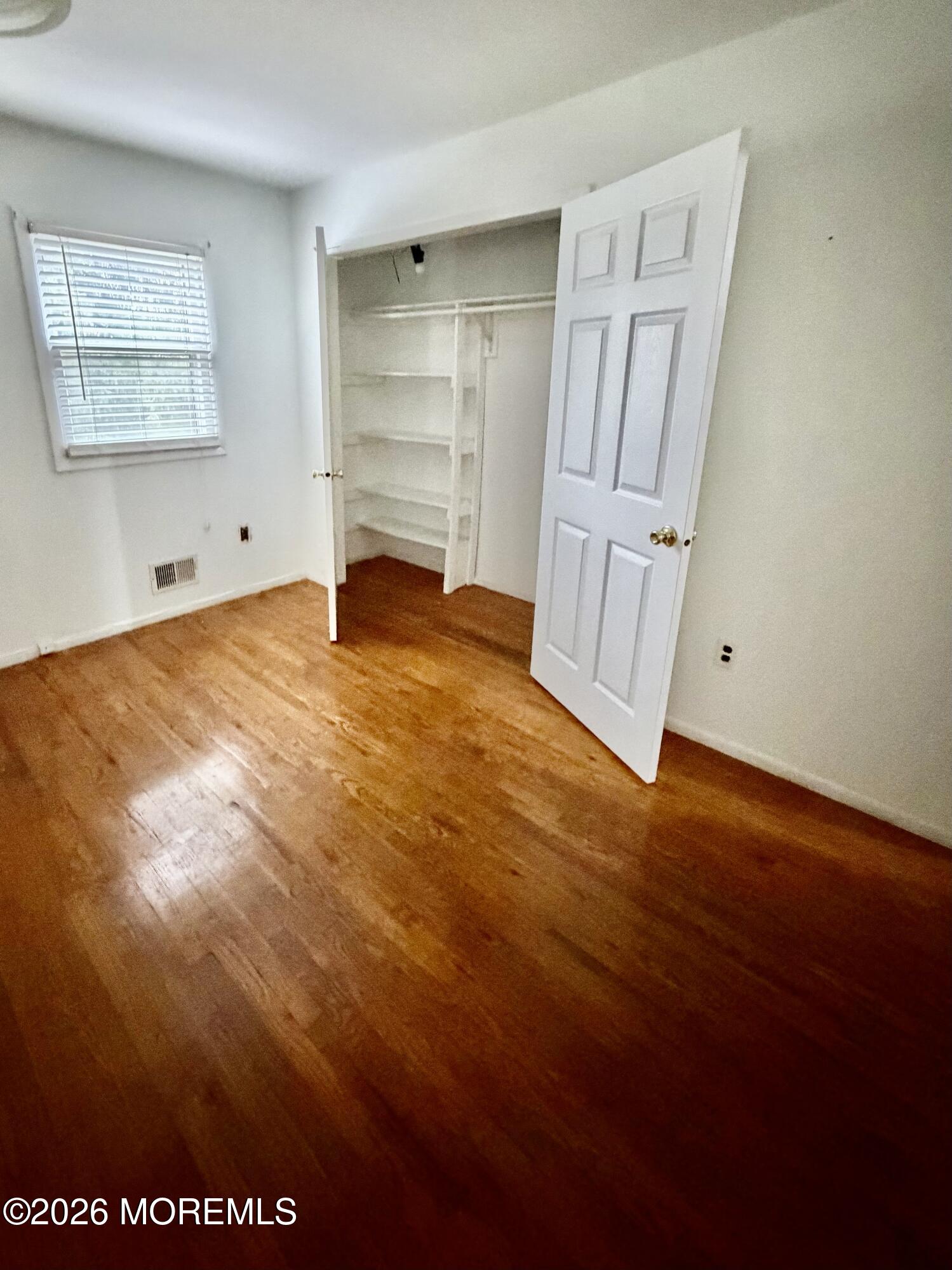 350 Bartley Road Jackson, NJ 08527 - Photo 20 of 29 a view of empty room with cabinet and wooden floor