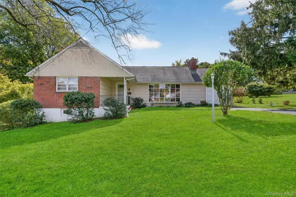 a front view of house with yard and green space