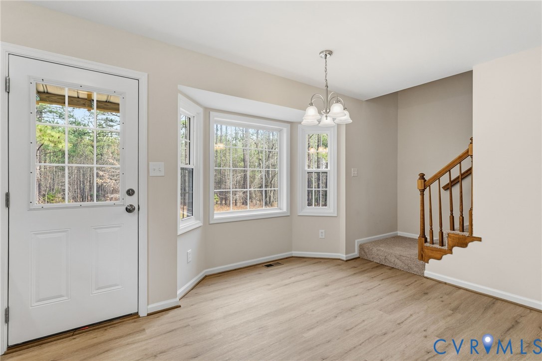 14624 Wilkinson Road Dewitt, VA 23840 - Photo 11 of 47 a view of a room with wooden floor fan and windows