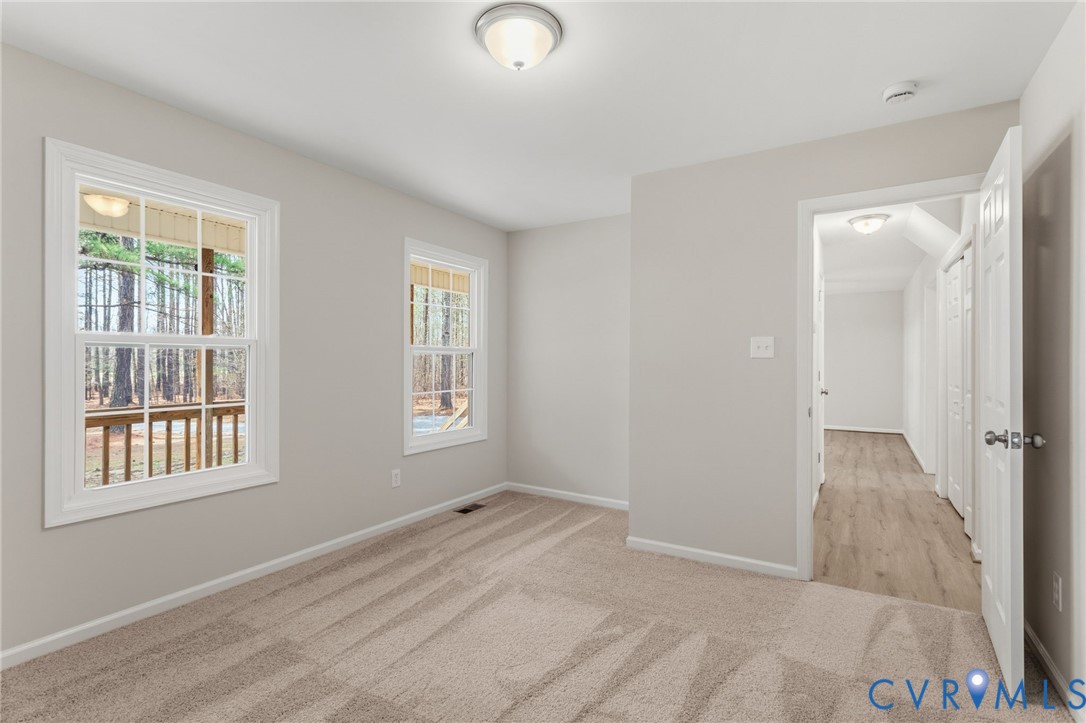 14624 Wilkinson Road Dewitt, VA 23840 - Photo 14 of 47 an empty room with windows and closet