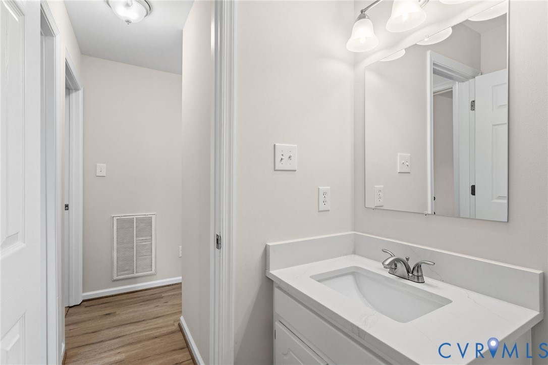 14624 Wilkinson Road Dewitt, VA 23840 - Photo 17 of 47 a bathroom with a sink vanity and a mirror