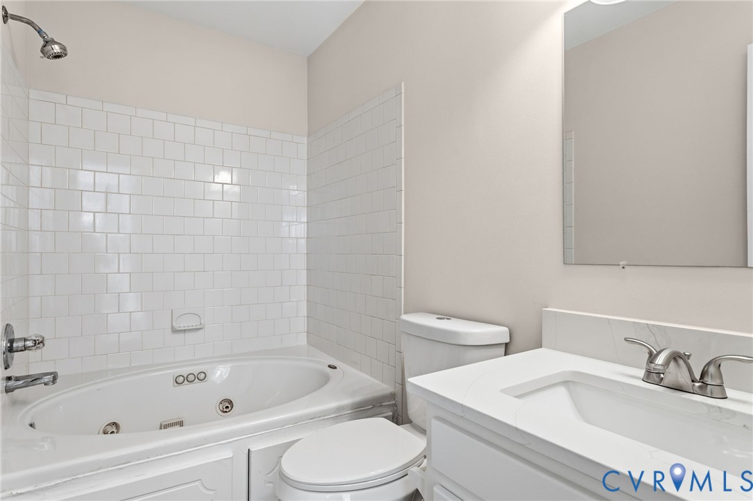 14624 Wilkinson Road Dewitt, VA 23840 - Photo 25 of 47 a bathroom with a bathtub shower sink vanity and toilet