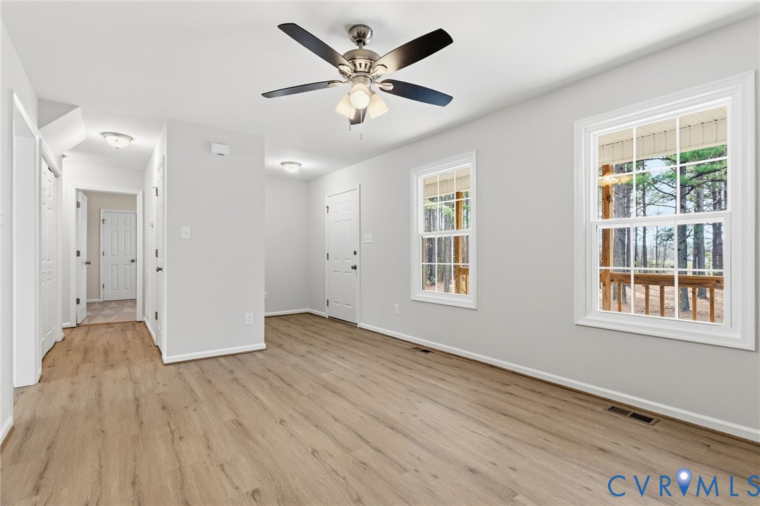 14624 Wilkinson Road Dewitt, VA 23840 - Photo 4 of 47 an empty room with wooden floor and windows