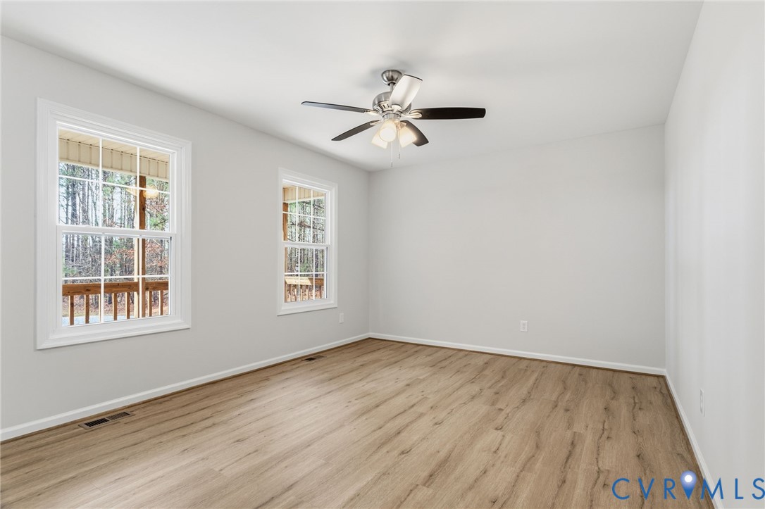 14624 Wilkinson Road Dewitt, VA 23840 - Photo 6 of 47 a view of empty room with wooden floor and fan