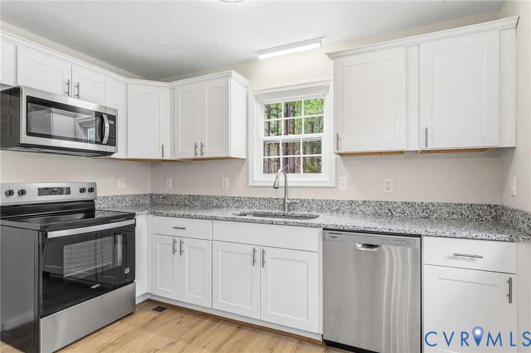 14624 Wilkinson Road Dewitt, VA 23840 - Photo 8 of 47 a kitchen with granite countertop cabinets stainless steel appliances and a sink