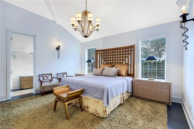 a bedroom with a bed and a table chair