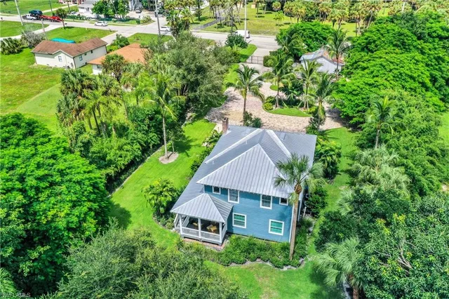an aerial view of residential house with outdoor space and trees around