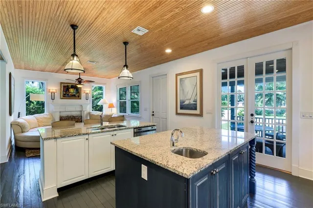 a kitchen with a sink a counter space and wooden floor