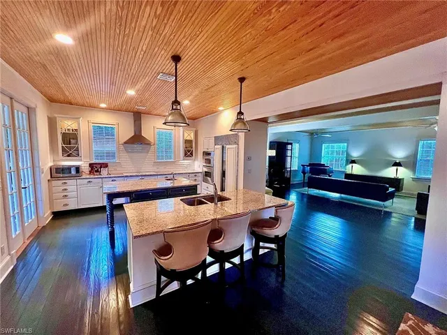 a kitchen with sink cabinets and wooden floor