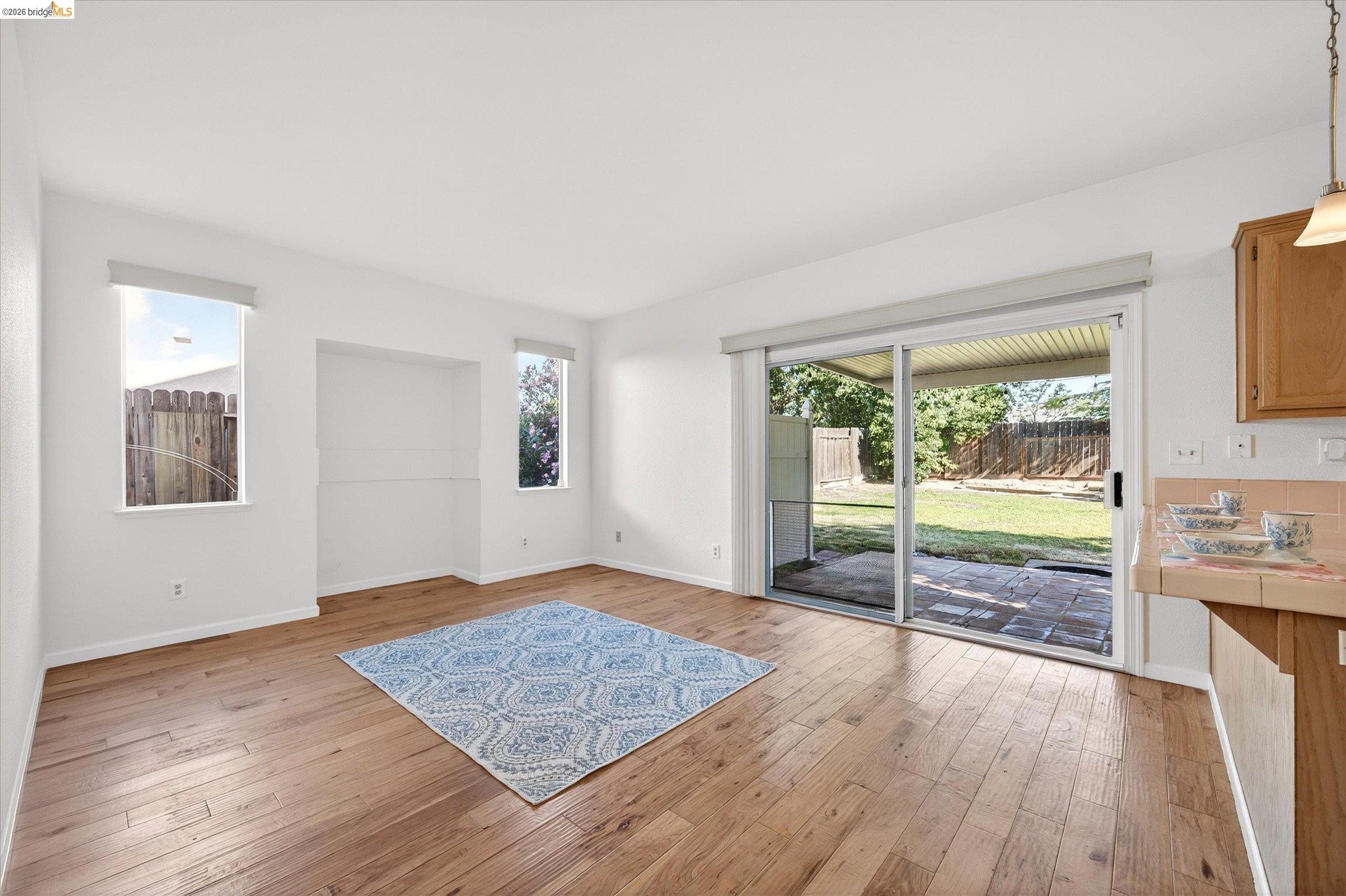 1120 Deerpark Road Oakley, CA 94561 - Photo 11 of 30 Spacious interior featuring wood-finish flooring, white walls, and a built-in wall niche