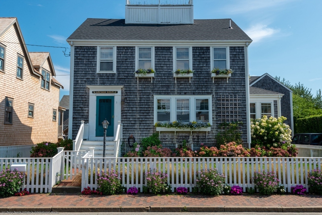 3 North Beach Street Nantucket, MA 02554 - Photo 13 of 13 a front view of a house with a garden