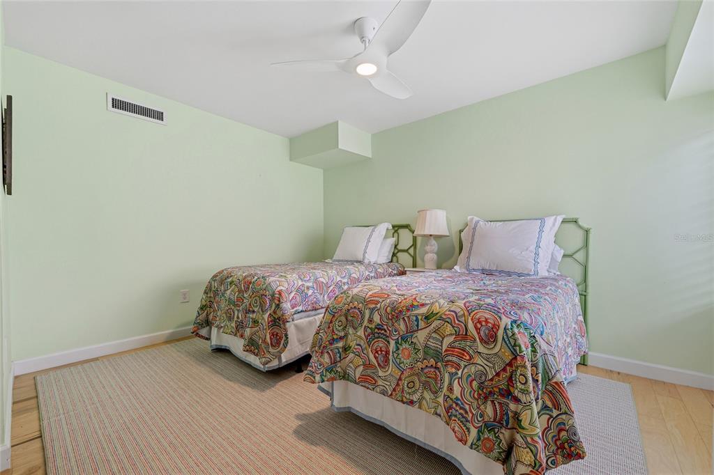 6206 Masters Boulevard, Unit 302 Orlando, FL 32819 - Photo 14 of 32 a bedroom with a bed and wooden floor