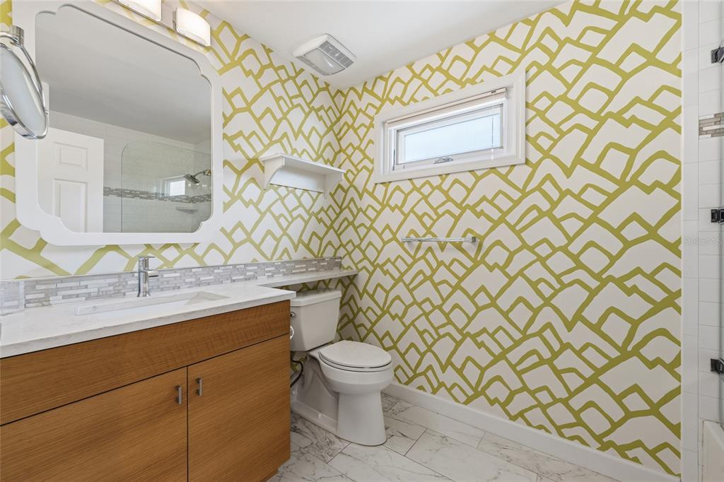 6206 Masters Boulevard, Unit 302 Orlando, FL 32819 - Photo 15 of 32 a bathroom with a granite countertop sink and a toilet