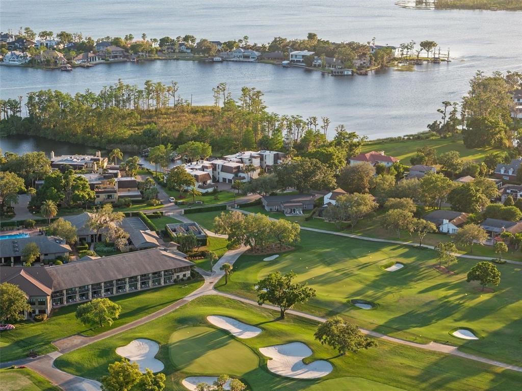 6206 Masters Boulevard, Unit 302 Orlando, FL 32819 - Photo 24 of 32 an aerial view of residential houses with outdoor space and lake view